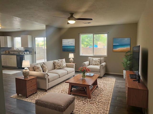 3005 Quail Point Dr, Albuquerque, NM 87120 - living area with plenty of natural light, a ceiling fan, dark wood-style floors, and a textured ceiling