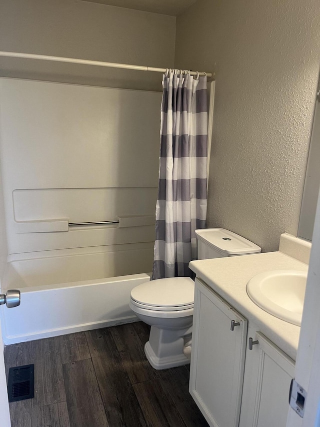 3005 Quail Point Dr, Albuquerque, NM 87120 - full bathroom featuring vanity, wood finished floors, a textured wall, and shower / tub combo with curtain