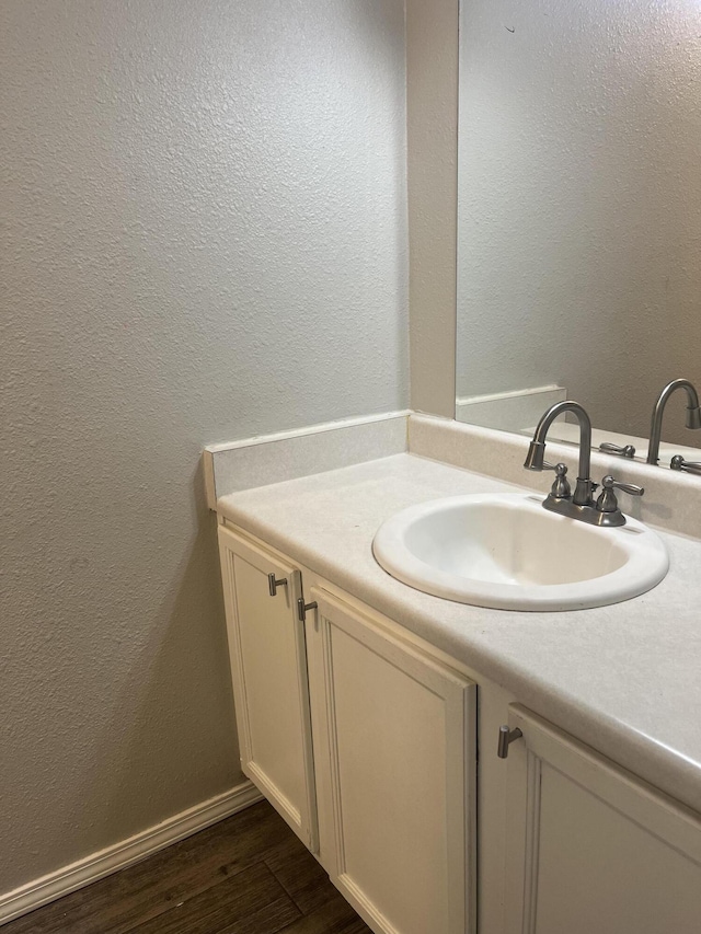 3005 Quail Point Dr, Albuquerque, NM 87120 - bathroom featuring vanity, a textured wall, and wood finished floors