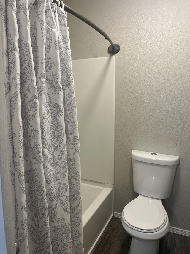 3005 Quail Point Dr, Albuquerque, NM 87120 - bathroom featuring wood finished floors and shower / bath combo with shower curtain