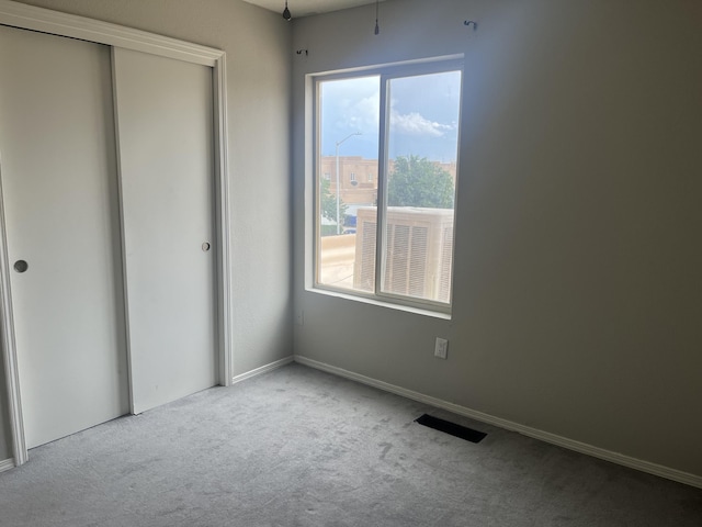 3005 Quail Point Dr, Albuquerque, NM 87120 - unfurnished bedroom featuring carpet flooring, multiple windows, and a closet