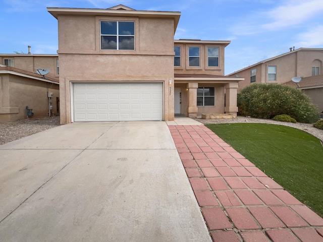 5355 Feather Rock Pl NW, Albuquerque, NM 87114 - traditional home with an attached garage, driveway, stucco siding, and a front yard