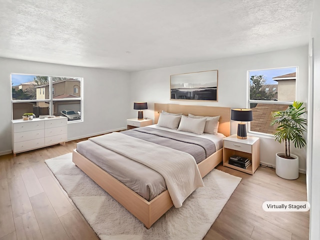 5355 Feather Rock Pl NW, Albuquerque, NM 87114 - bedroom featuring a textured ceiling and wood finished floors