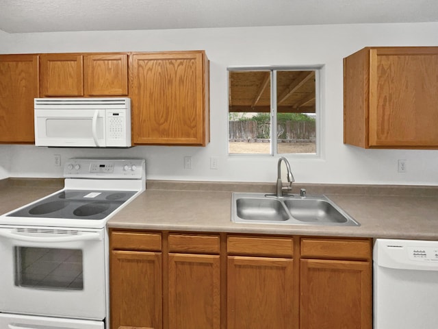 5355 Feather Rock Pl NW, Albuquerque, NM 87114 - kitchen featuring white appliances and brown cabinetry