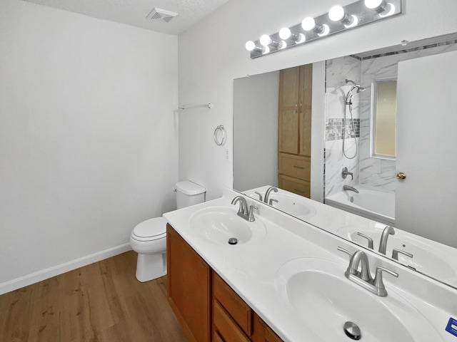 5355 Feather Rock Pl NW, Albuquerque, NM 87114 - bathroom featuring double vanity, wood finished floors, and bathtub / shower combination