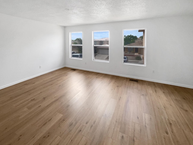 5355 Feather Rock Pl NW, Albuquerque, NM 87114 - unfurnished room featuring wood finished floors and a textured ceiling