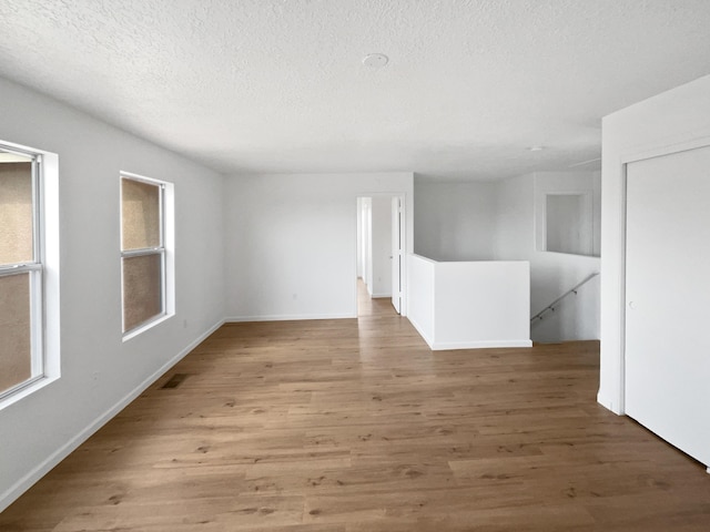 5355 Feather Rock Pl NW, Albuquerque, NM 87114 - empty room with a textured ceiling and wood finished floors