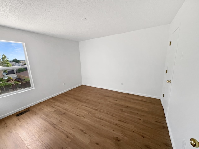 5355 Feather Rock Pl NW, Albuquerque, NM 87114 - empty room with wood finished floors and a textured ceiling