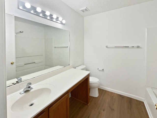 5355 Feather Rock Pl NW, Albuquerque, NM 87114 - bathroom with vanity, wood finished floors, tub / shower combination, and a textured ceiling