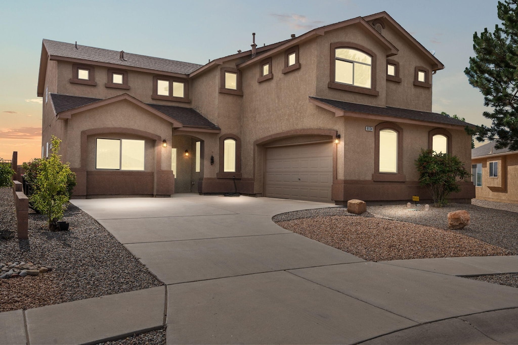 8134 Sand Springs Cir NW, Albuquerque, NM 87114 - view of front facade with a garage, driveway, and stucco siding