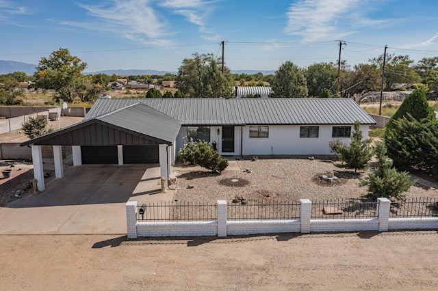 4320 Blumenshine Cir SW, Albuquerque, NM 87105 - view of front of house featuring a fenced front yard, a metal roof, driveway, and a garage