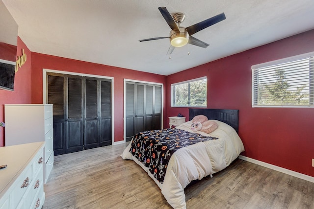 4320 Blumenshine Cir SW, Albuquerque, NM 87105 - bedroom featuring two closets, light wood-style floors, and a ceiling fan