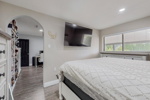 4320 Blumenshine Cir SW, Albuquerque, NM 87105 - bedroom featuring wood finished floors, arched walkways, and recessed lighting