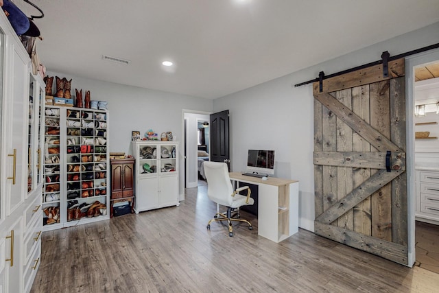 4320 Blumenshine Cir SW, Albuquerque, NM 87105 - home office featuring wood finished floors, a barn door, and recessed lighting