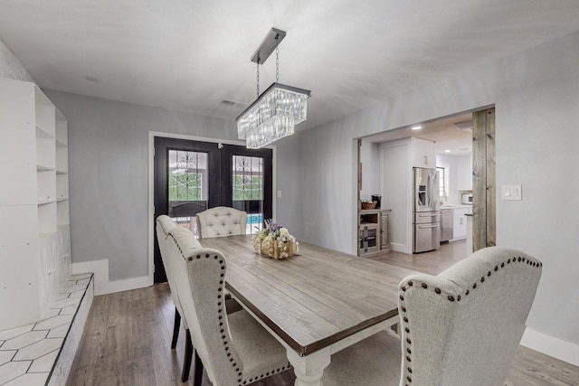 4320 Blumenshine Cir SW, Albuquerque, NM 87105 - dining room featuring a chandelier, light wood-type flooring, and french doors