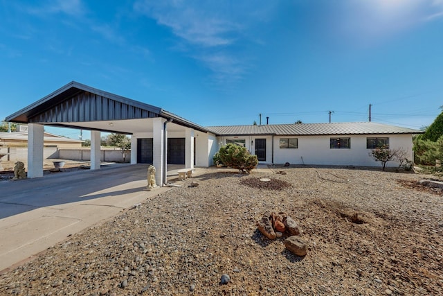 4320 Blumenshine Cir SW, Albuquerque, NM 87105 - view of front facade with a garage, concrete driveway, a metal roof, and stucco siding