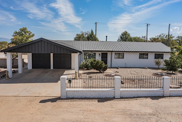 4320 Blumenshine Cir SW, Albuquerque, NM 87105 - view of front of home featuring a fenced front yard, a garage, concrete driveway, a metal roof, and brick siding