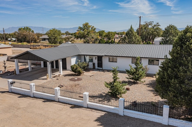 4320 Blumenshine Cir SW, Albuquerque, NM 87105 - single story home featuring a fenced front yard, a metal roof, a carport, a mountain view, and driveway