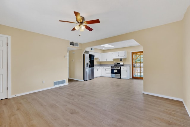 10409 Britt Ct NE, Albuquerque, NM 87112 - unfurnished living room featuring ceiling fan, arched walkways, and light wood-type flooring