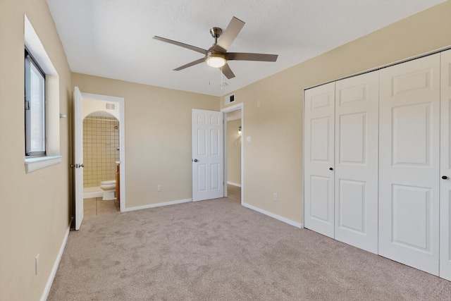 10409 Britt Ct NE, Albuquerque, NM 87112 - unfurnished bedroom featuring carpet flooring, a closet, ensuite bath, and ceiling fan