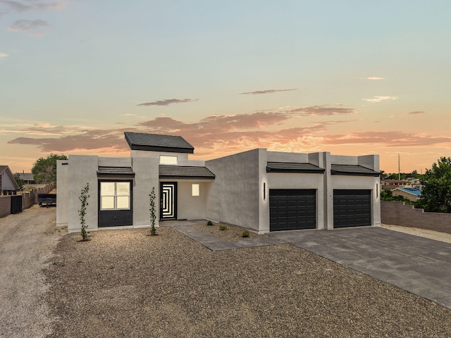 1109 11th St SE, Rio Rancho, NM 87124 - contemporary home featuring a garage, driveway, and stucco siding