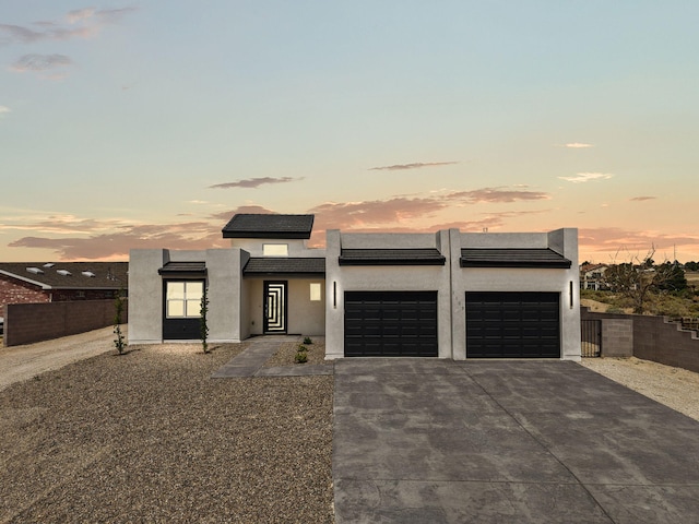 1109 11th St SE, Rio Rancho, NM 87124 - view of front of home with an attached garage, stucco siding, and driveway