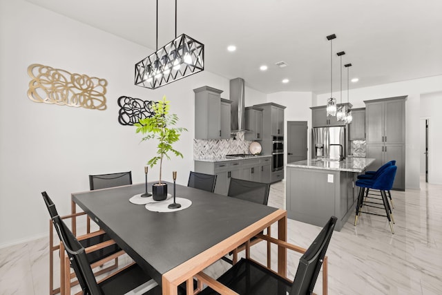 1109 11th St SE, Rio Rancho, NM 87124 - dining room with light marble finish floors, a chandelier, and recessed lighting