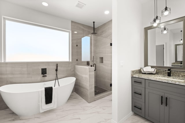 1109 11th St SE, Rio Rancho, NM 87124 - full bathroom with marble finish flooring, a stall shower, vanity, a freestanding bath, and recessed lighting