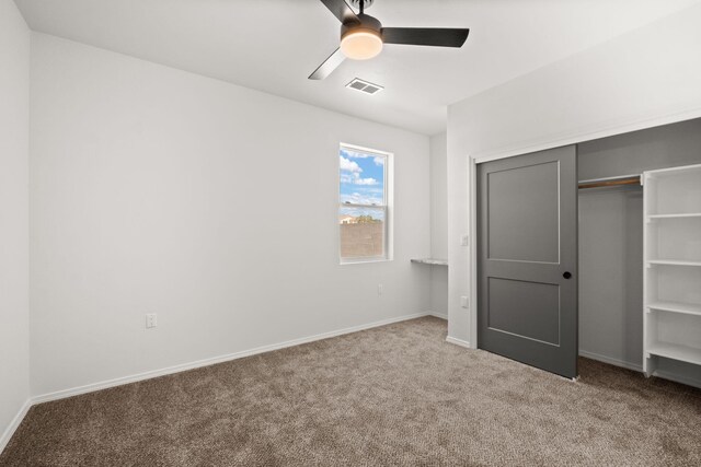 1109 11th St SE, Rio Rancho, NM 87124 - unfurnished bedroom featuring carpet flooring, a closet, and a ceiling fan