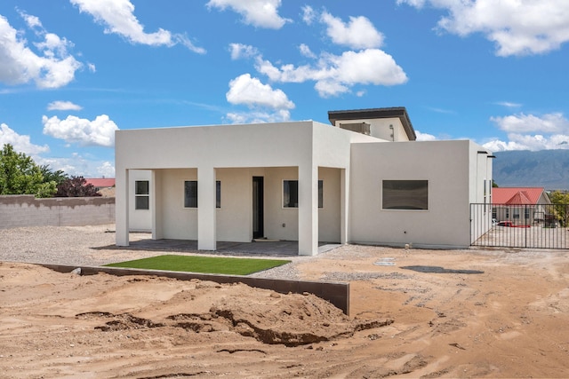 1109 11th St SE, Rio Rancho, NM 87124 - back of house with stucco siding and a patio area