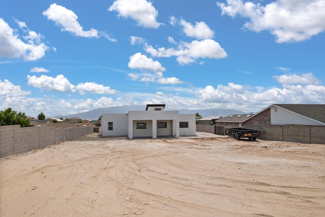 1109 11th St SE, Rio Rancho, NM 87124 - back of property featuring stucco siding and a mountain view