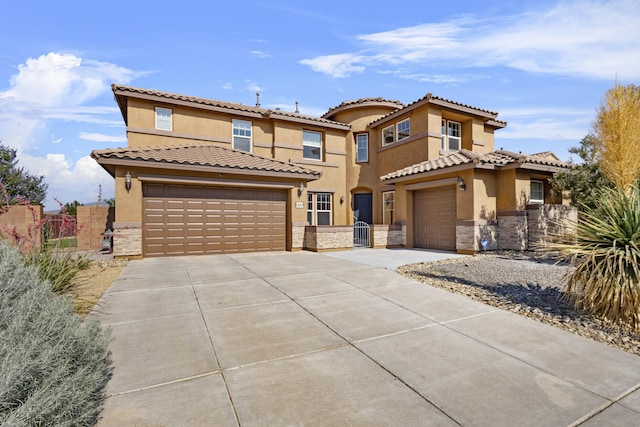 44 Los Balcones Pl NE, Rio Rancho, NM 87124 - view of front facade with stone siding, concrete driveway, and stucco siding