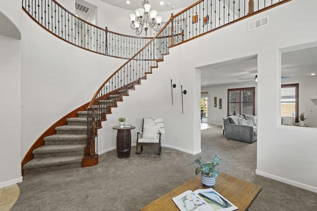 44 Los Balcones Pl NE, Rio Rancho, NM 87124 - carpeted foyer entrance featuring stairway, a high ceiling, ceiling fan, a chandelier, and recessed lighting