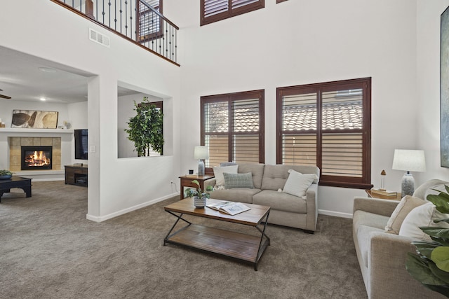 44 Los Balcones Pl NE, Rio Rancho, NM 87124 - carpeted living room featuring a fireplace, a high ceiling, and ceiling fan