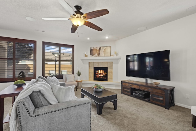 44 Los Balcones Pl NE, Rio Rancho, NM 87124 - living area with ceiling fan, carpet floors, and a tiled fireplace