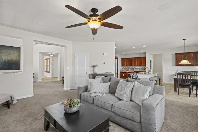 44 Los Balcones Pl NE, Rio Rancho, NM 87124 - living room featuring a ceiling fan, light carpet, recessed lighting, and a textured ceiling