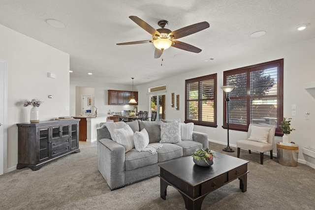 44 Los Balcones Pl NE, Rio Rancho, NM 87124 - living room featuring light carpet, ceiling fan, and recessed lighting