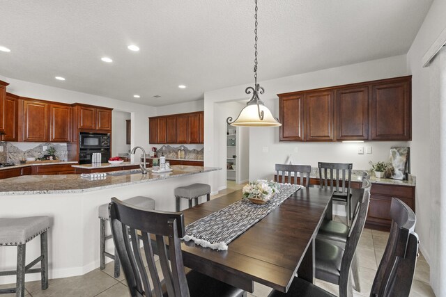 44 Los Balcones Pl NE, Rio Rancho, NM 87124 - dining area with light tile patterned floors, recessed lighting, and a textured ceiling