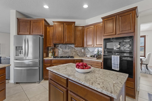 44 Los Balcones Pl NE, Rio Rancho, NM 87124 - kitchen with black appliances, light tile patterned flooring, light stone counters, a textured ceiling, and recessed lighting