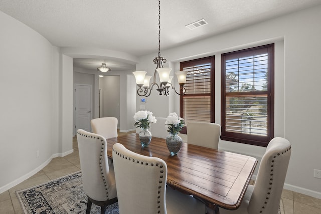 44 Los Balcones Pl NE, Rio Rancho, NM 87124 - dining room featuring a chandelier, light tile patterned flooring, and a textured ceiling