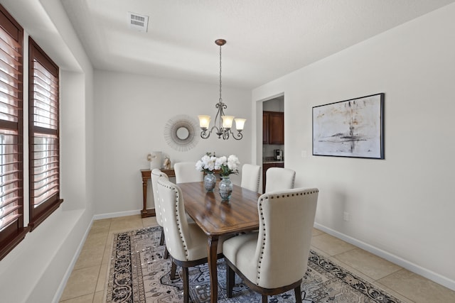 44 Los Balcones Pl NE, Rio Rancho, NM 87124 - dining room with light tile patterned floors and a chandelier
