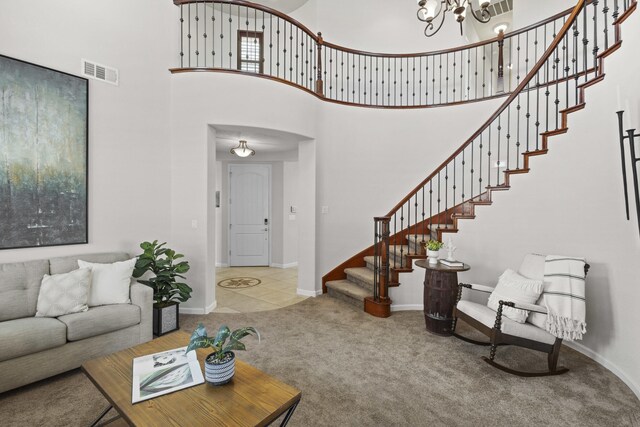 44 Los Balcones Pl NE, Rio Rancho, NM 87124 - carpeted living area featuring stairs, a towering ceiling, and a chandelier