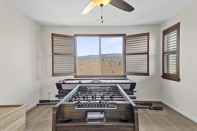 44 Los Balcones Pl NE, Rio Rancho, NM 87124 - game room with carpet floors, plenty of natural light, ceiling fan, and a textured ceiling