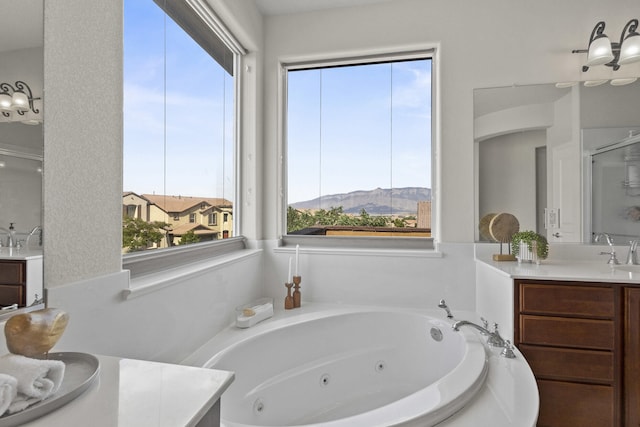 44 Los Balcones Pl NE, Rio Rancho, NM 87124 - full bathroom with vanity, a jetted tub, a mountain view, and a stall shower