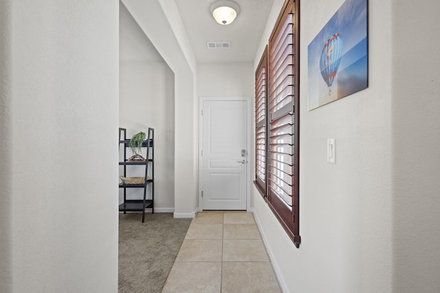 44 Los Balcones Pl NE, Rio Rancho, NM 87124 - hall featuring light tile patterned floors and light colored carpet