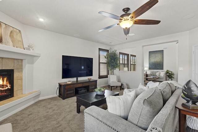 44 Los Balcones Pl NE, Rio Rancho, NM 87124 - carpeted living area featuring ceiling fan and a tiled fireplace