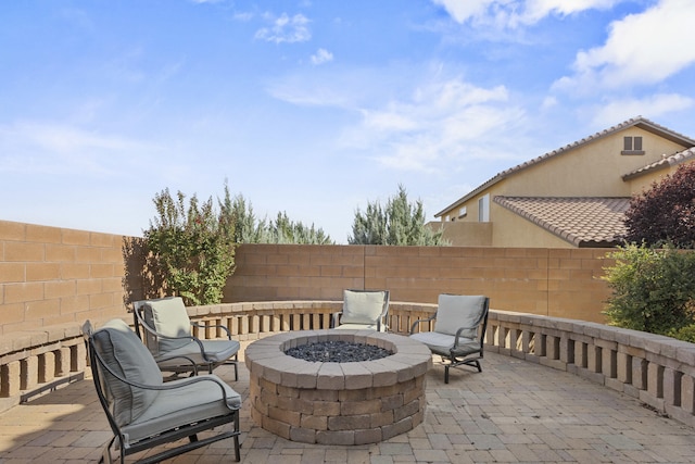44 Los Balcones Pl NE, Rio Rancho, NM 87124 - fenced backyard featuring an outdoor fire pit and a patio area