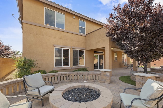 44 Los Balcones Pl NE, Rio Rancho, NM 87124 - back of property with a patio area, stucco siding, and an outdoor fire pit