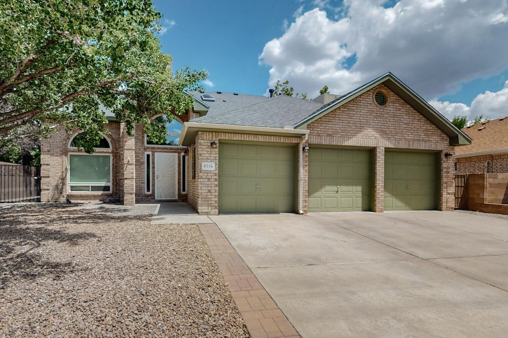 8316 Calle Primera NW, Albuquerque, NM 87120 - single story home featuring brick siding, concrete driveway, a garage, and roof with shingles