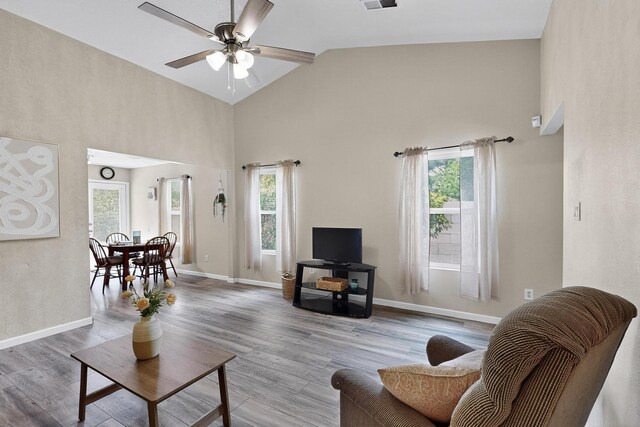 10639 Miera Dr NW, Albuquerque, NM 87114 - living area featuring plenty of natural light, high vaulted ceiling, ceiling fan, and wood finished floors